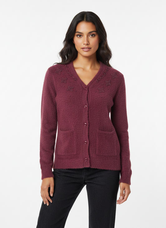 Model wearing a Cozy&Drape burgundy fuzzy knit cardigan with beaded floral neckline, button front, and patch pockets.