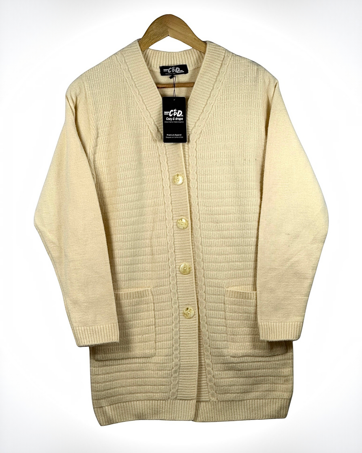 Cozy&Drape cream long cardigan sweater with a button-up front, ribbed texture, and two convenient front pockets.