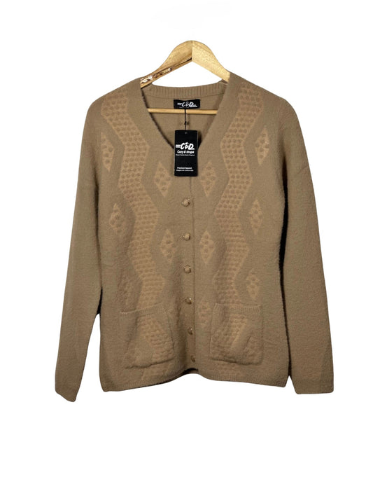 Cozy&Drape tan button-up cardigan sweater with textured diamond pattern and front pockets on a wooden hanger