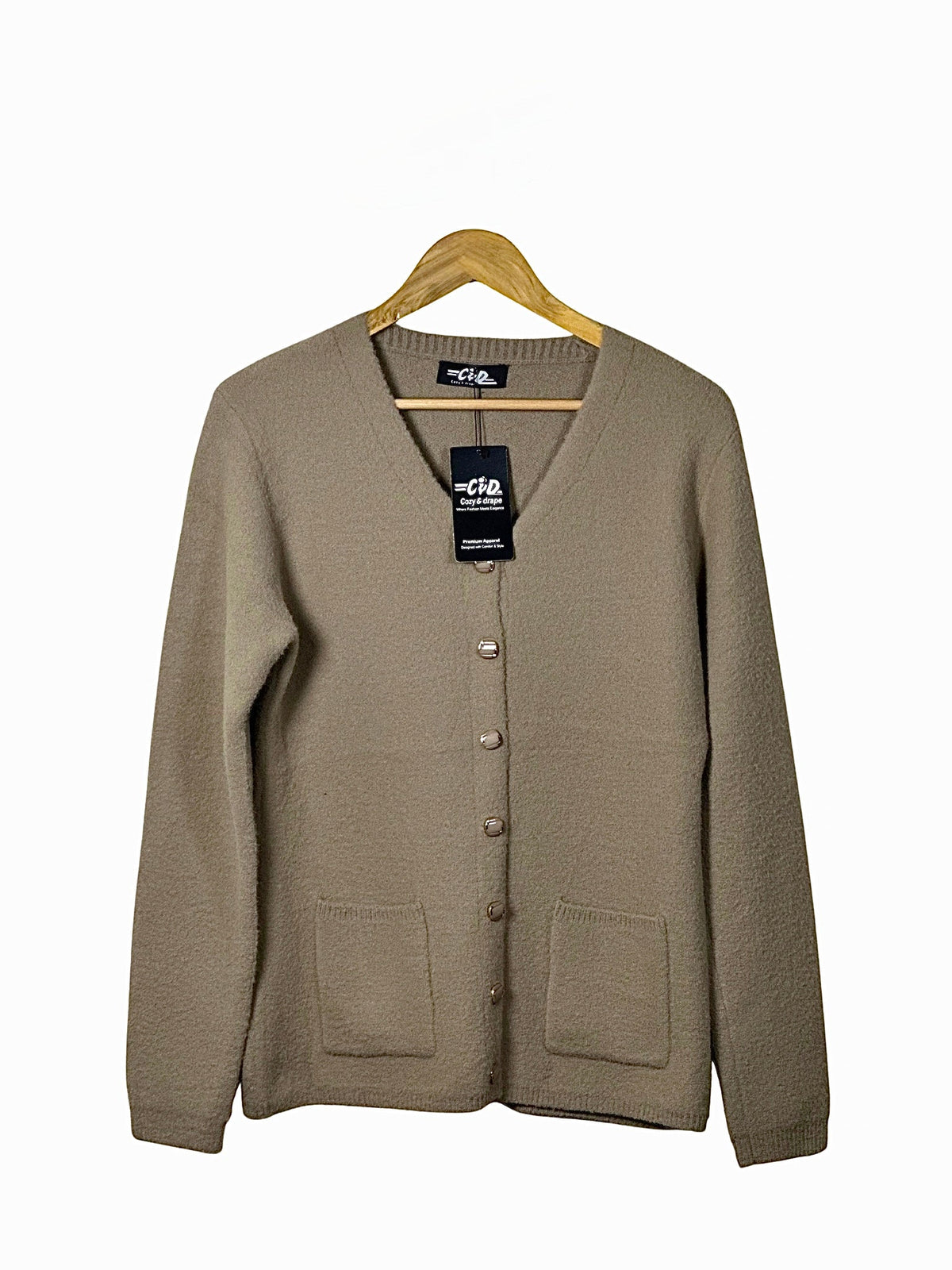 Cozy&Drape beige full-sleeve cardigan sweater with front pockets and button-down closure on a wooden hanger