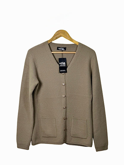 Cozy&Drape beige full-sleeve cardigan sweater with front pockets and button-down closure on a wooden hanger