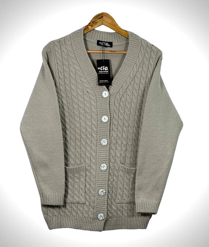 Cozy&Drape beige cable knit cardigan sweater with front buttons and pockets on a wooden hanger
