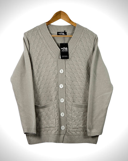 Cozy&Drape beige cable knit cardigan sweater with long sleeves, front buttons, and two pockets on a wooden hanger.