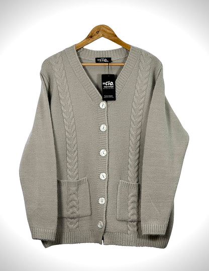 Cozy&Drape beige cable knit cardigan sweater with front buttons and pockets on a wooden hanger