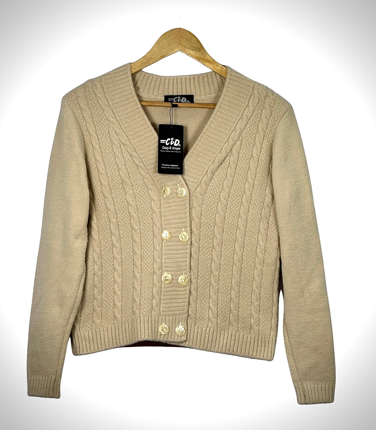 Cozy&Drape beige cable knit extra short cardigan sweater with a V-neck and four front buttons on a wooden hanger