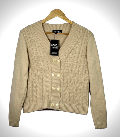 Cozy&Drape beige cable knit extra short cardigan sweater with a V-neck and four front buttons on a wooden hanger