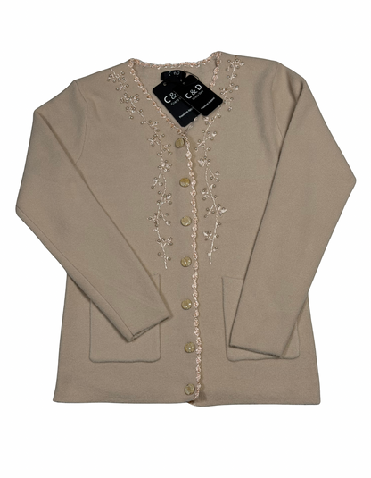 Cozy&Drape beige knit cardigan with V-neck, floral embroidery along the button placket, and two front pockets.