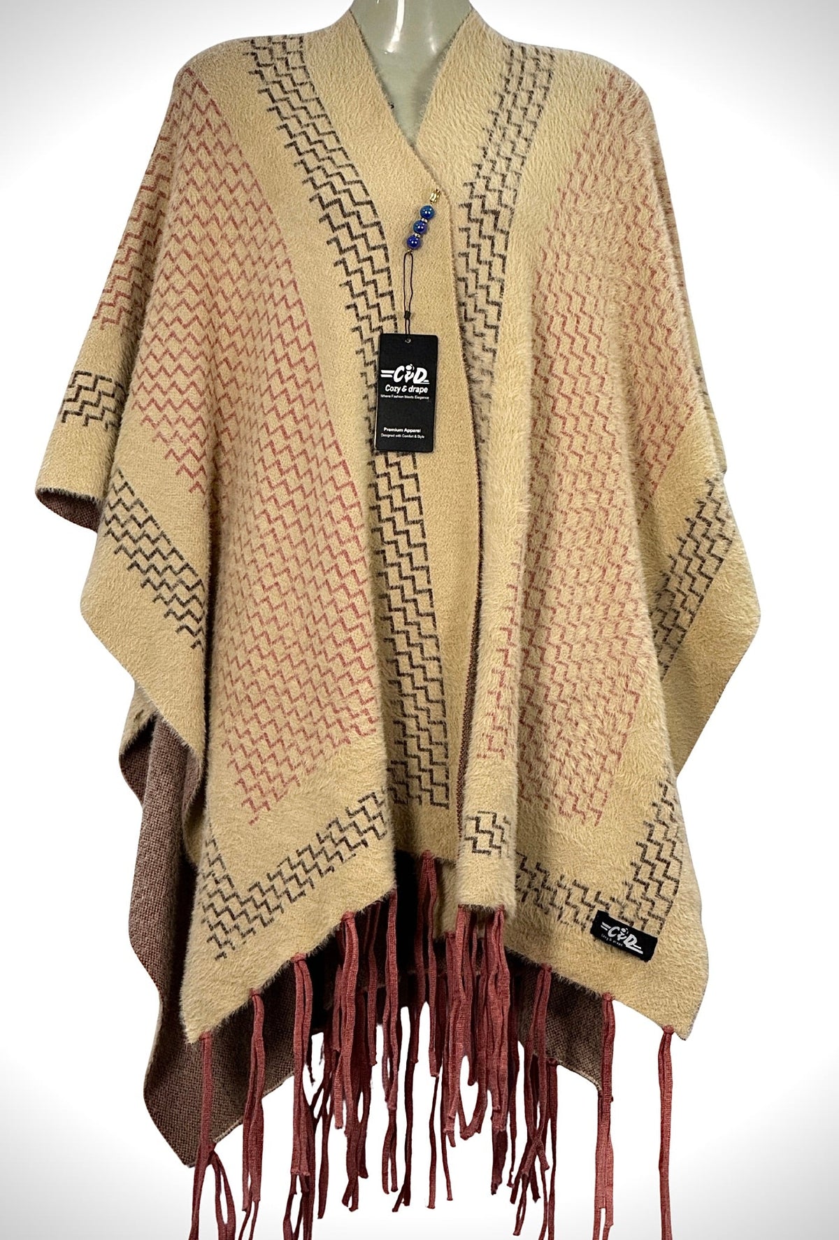 Cozy&Drape beige winter cape shawl with geometric patterns and red fringe trim for elegant, warm everyday wear.