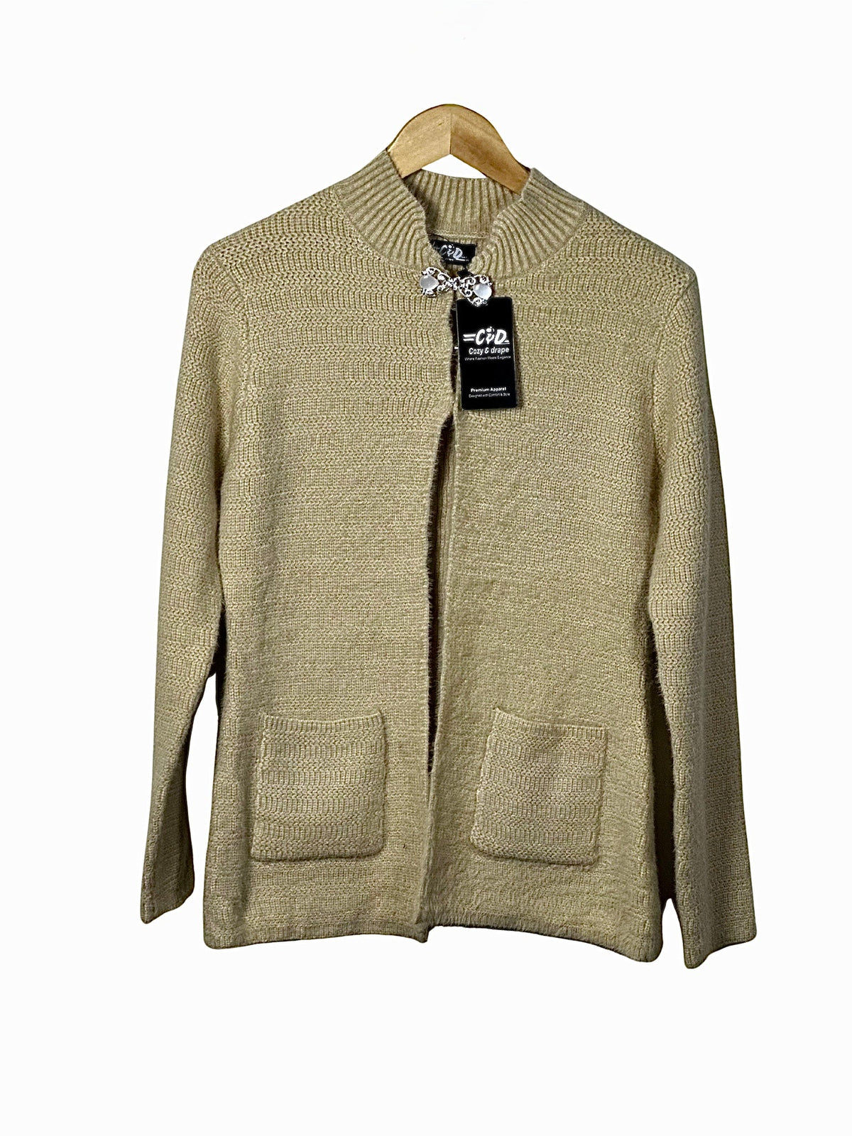 Cozy&Drape beige open-front knit cardigan sweater with long sleeves and two front pockets on a wooden hanger