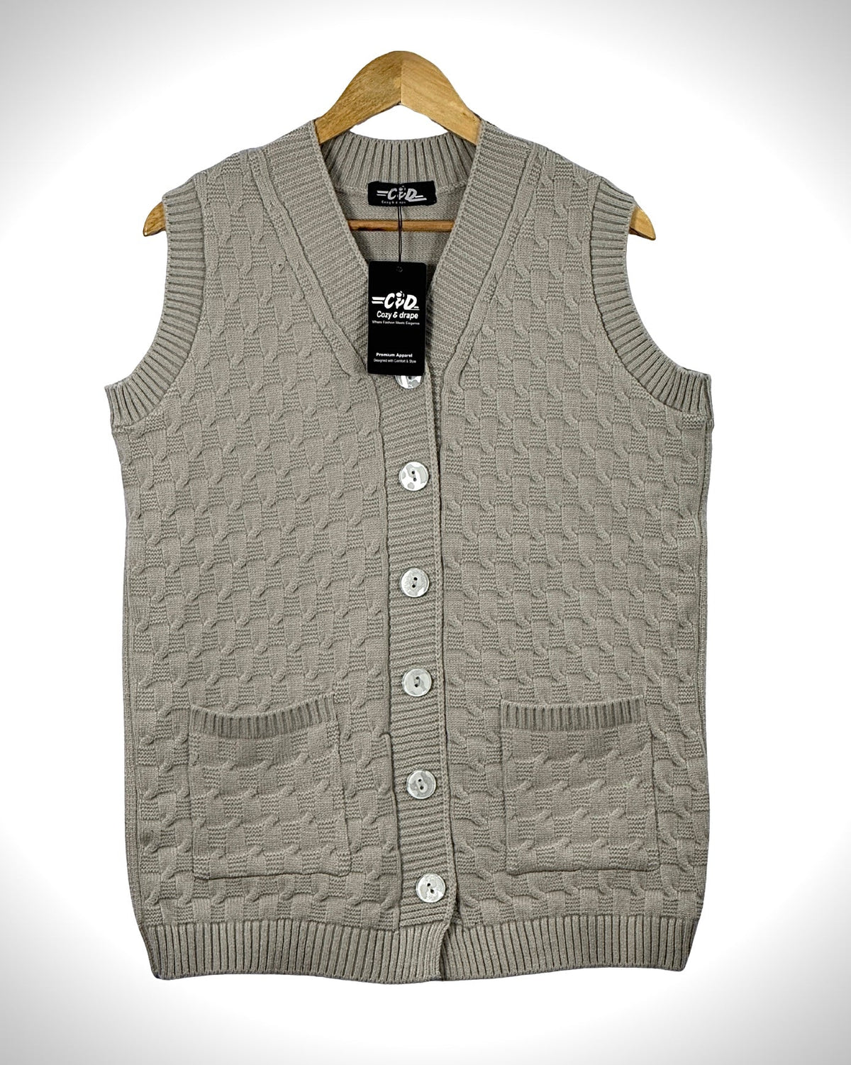 Cozy&Drape sleeveless beige knit cardigan sweater with a V-neck, button front, and two front pockets on a hanger.