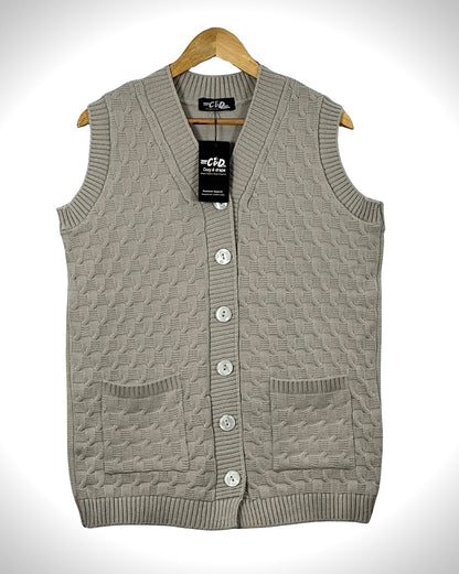 Cozy&Drape sleeveless beige knit cardigan sweater with a V-neck, button front, and two front pockets on a hanger.