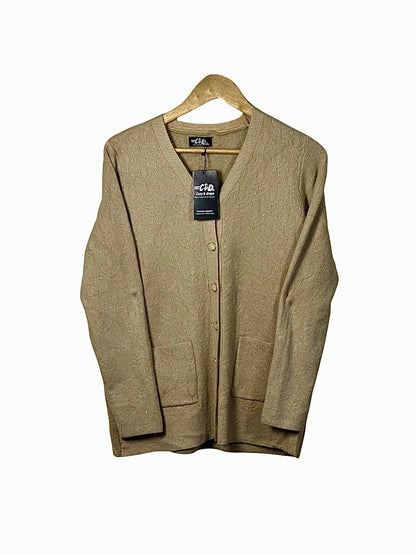 Cozy&Drape beige wool cardigan sweater with long sleeves, front buttons, and pockets hanging on a wooden hanger