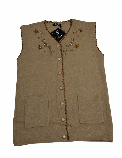 Cozy&Drape sleeveless wool cardigan in beige with floral bead embroidery, front buttons, and two patch pockets.