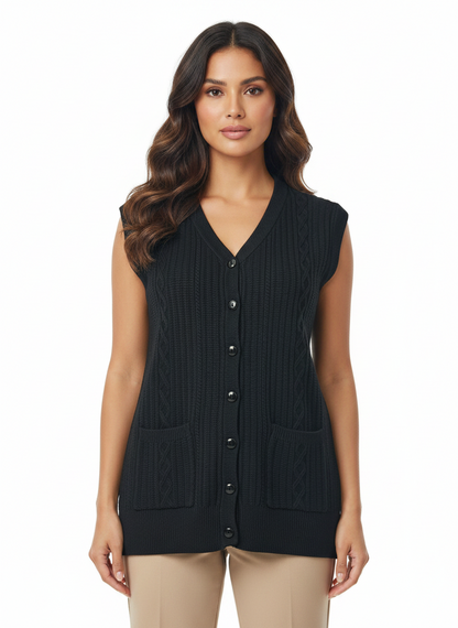 Model wearing a black Cozy&Drape sleeveless cable-knit cardigan with a V-neck, button front, and two front pockets.