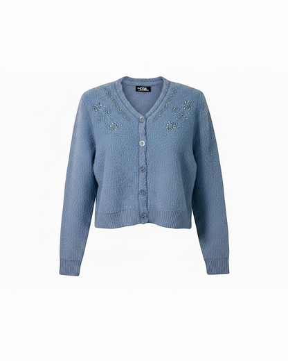 Cozy&Drape blue fuzzy knit cropped cardigan with V-neckline, floral beadwork embellishments, and front button closure.