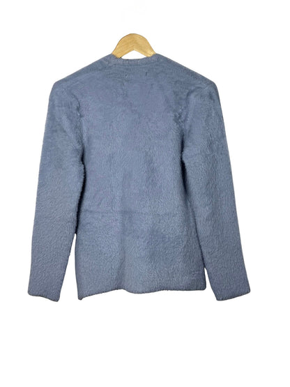 Cozy&Drape blue fuzzy long sleeve cardigan sweater on a wooden hanger, back view