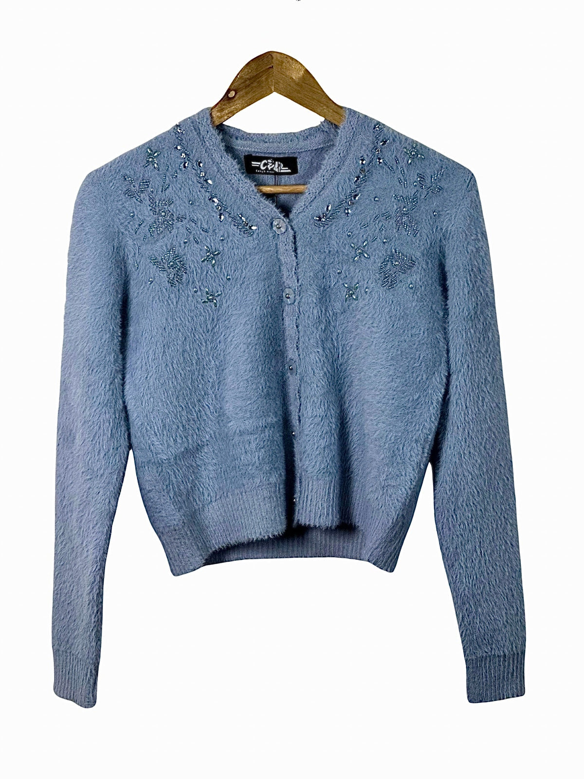Cozy&Drape extra short blue fuzzy cardigan sweater with delicate beaded floral embroidery on a wooden hanger