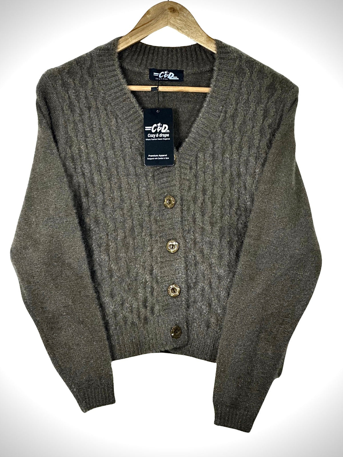 Cozy&Drape extra short brown cable knit cardigan sweater with a V-neck and four decorative buttons on a hanger.