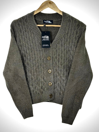 Cozy&Drape extra short brown cable knit cardigan sweater with a V-neck and four decorative buttons on a hanger.