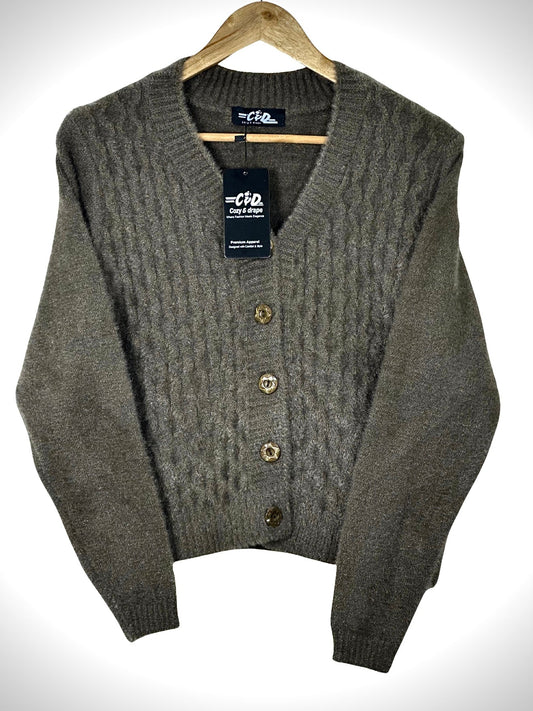 Cozy&Drape extra short brown cable knit cardigan sweater with a V-neck and four decorative buttons on a hanger.