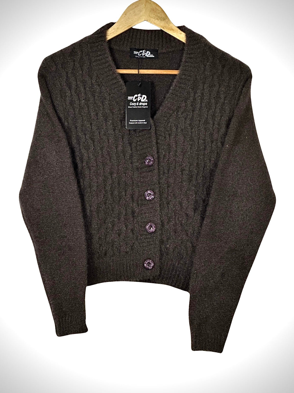 Cozy&Drape extra short brown cable knit cardigan sweater with decorative buttons on a wooden hanger