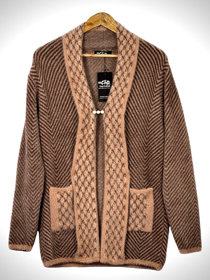 Cozy&Drape brown open front sweater with chevron pattern, textured trim, and front pockets on a wooden hanger.