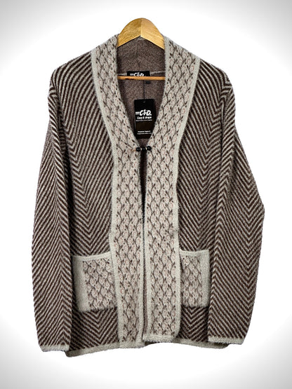 Cozy&Drape brown and beige open front sweater with chevron pattern, textured trim, and two front pockets on a hanger