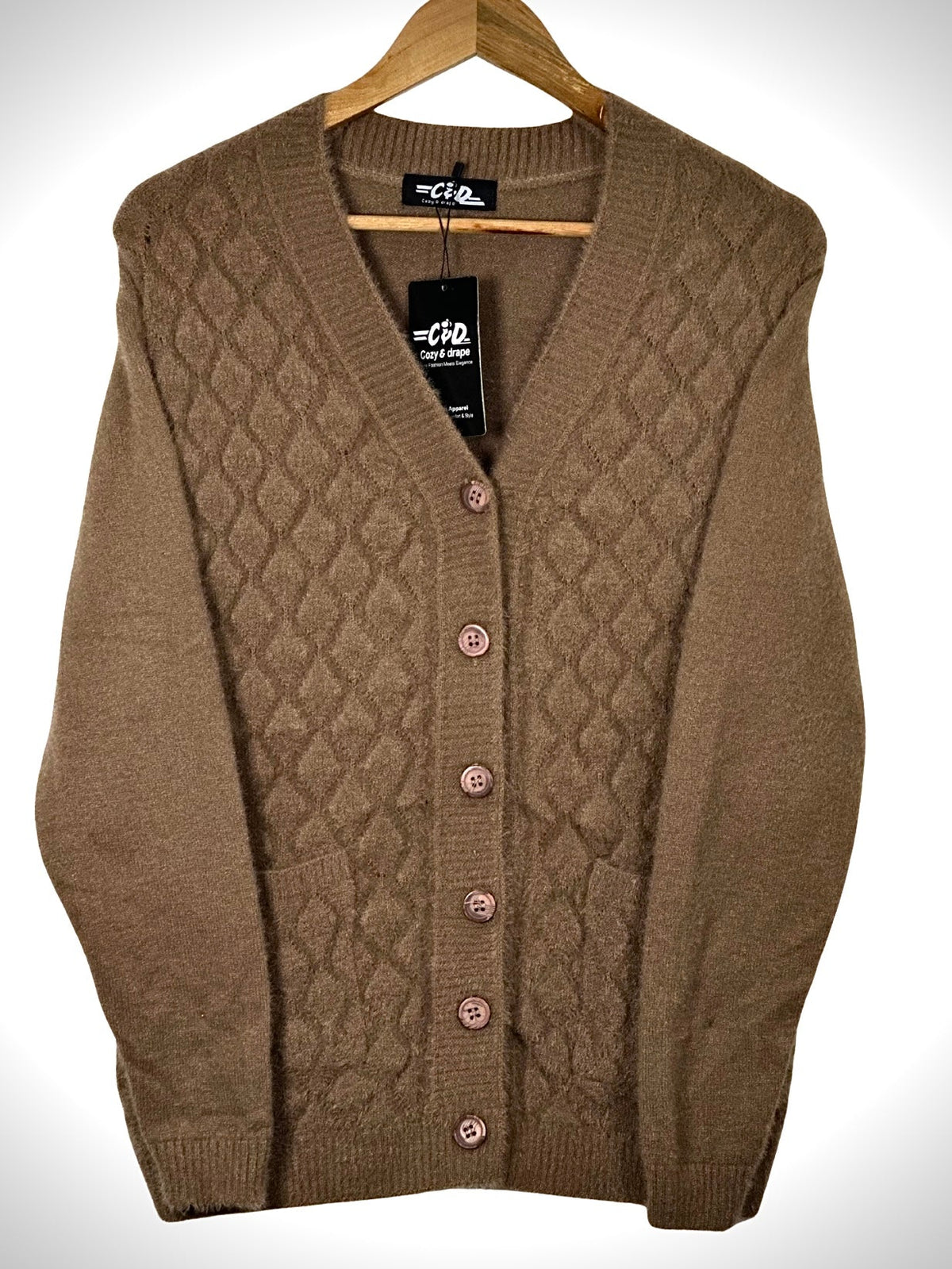 Cozy&Drape brown button-up cardigan sweater with a diamond-patterned knit and front pockets on a wooden hanger