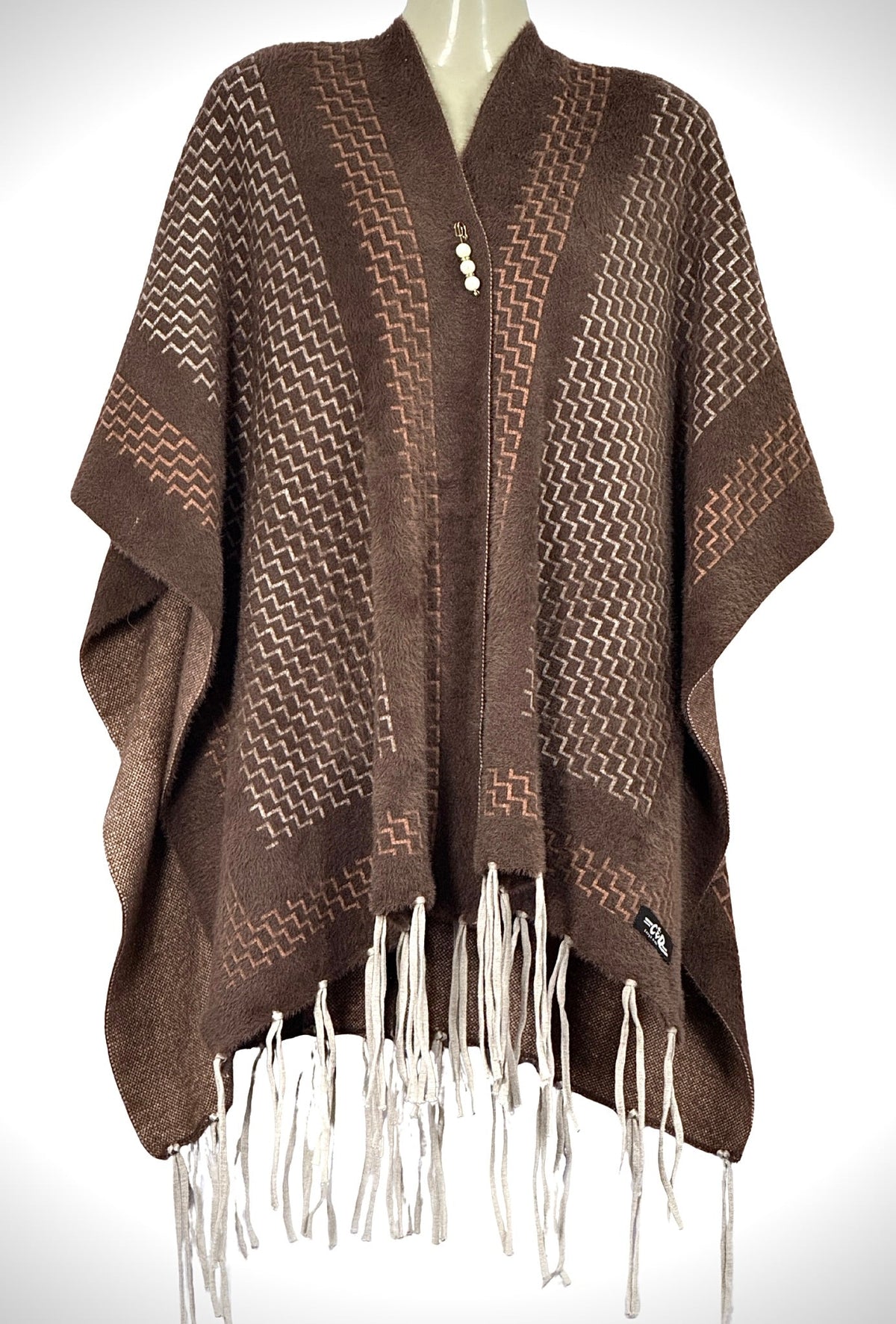 Cozy&Drape brown winter cape shawl with geometric zigzag pattern, front button closure, and white fringe hem.