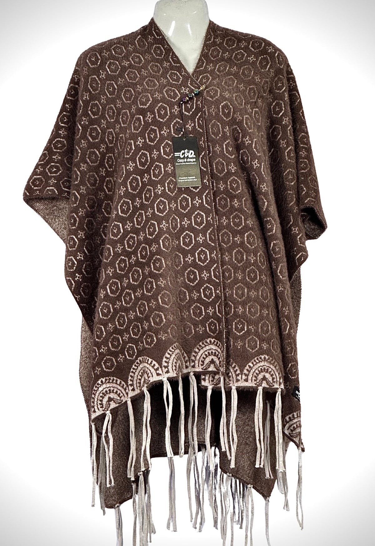 Cozy&Drape brown winter cape shawl with geometric patterns and fringe hem, featuring a comfortable adjustable fit.