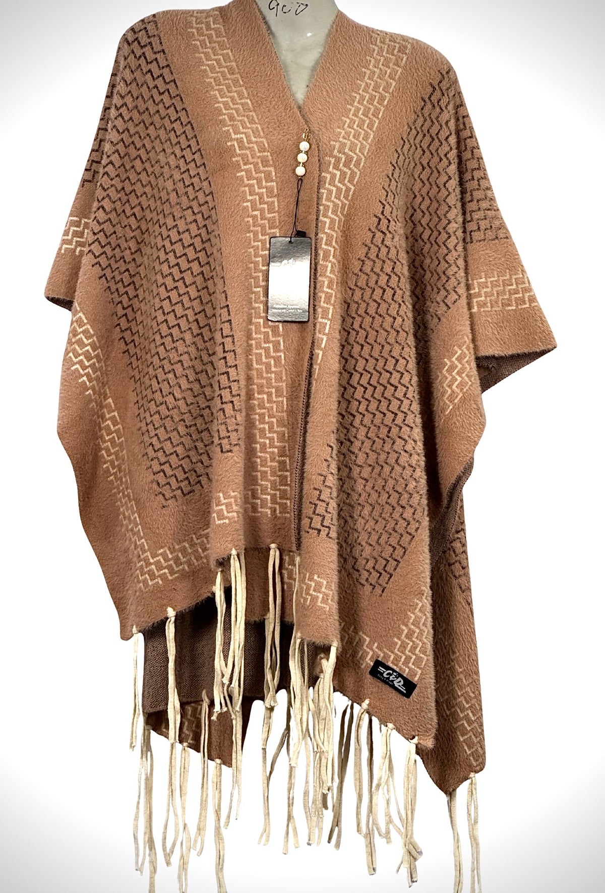 Cozy&Drape brown winter cape shawl with geometric zigzag pattern and cream fringe trim on a mannequin
