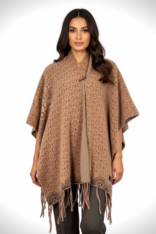 Model wearing a Cozy&Drape brown geometric patterned poncho wrap with fringe hem and decorative neckline closure