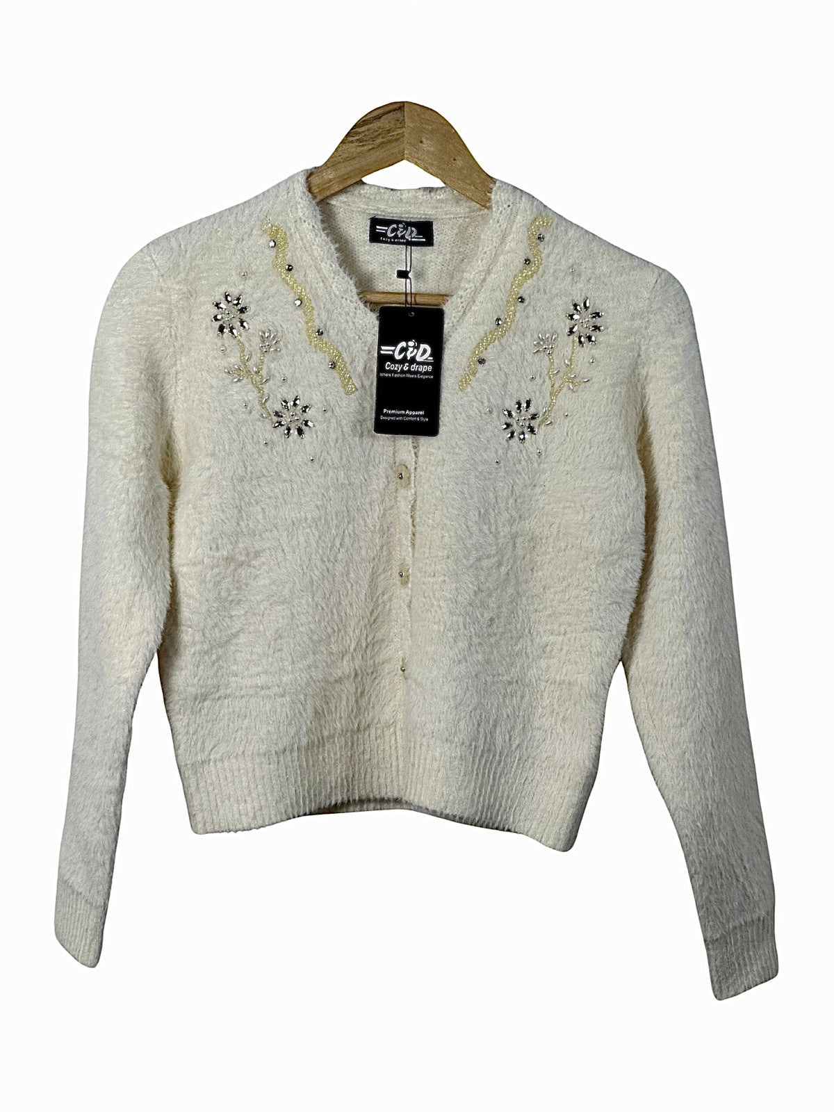 Cozy&Drape cream fuzzy cardigan sweater with delicate floral beadwork and button-front closure on a wooden hanger