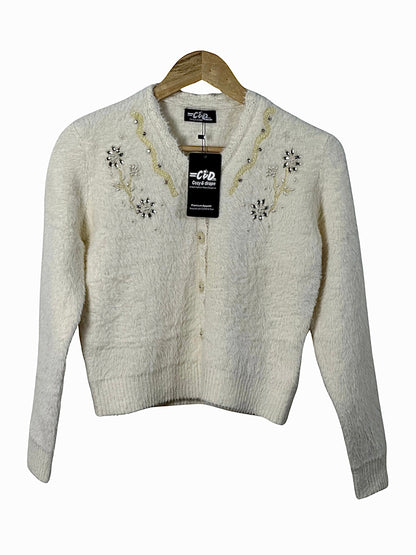 Cozy&Drape cream fuzzy cardigan sweater with delicate floral beadwork and button-front closure on a wooden hanger