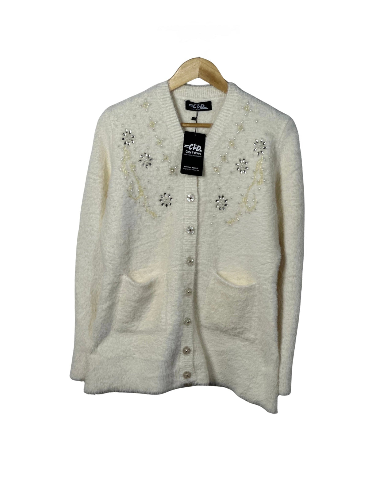 Cozy&Drape cream full sleeve cardigan sweater with beaded floral embellishments and front pockets on a wooden hanger