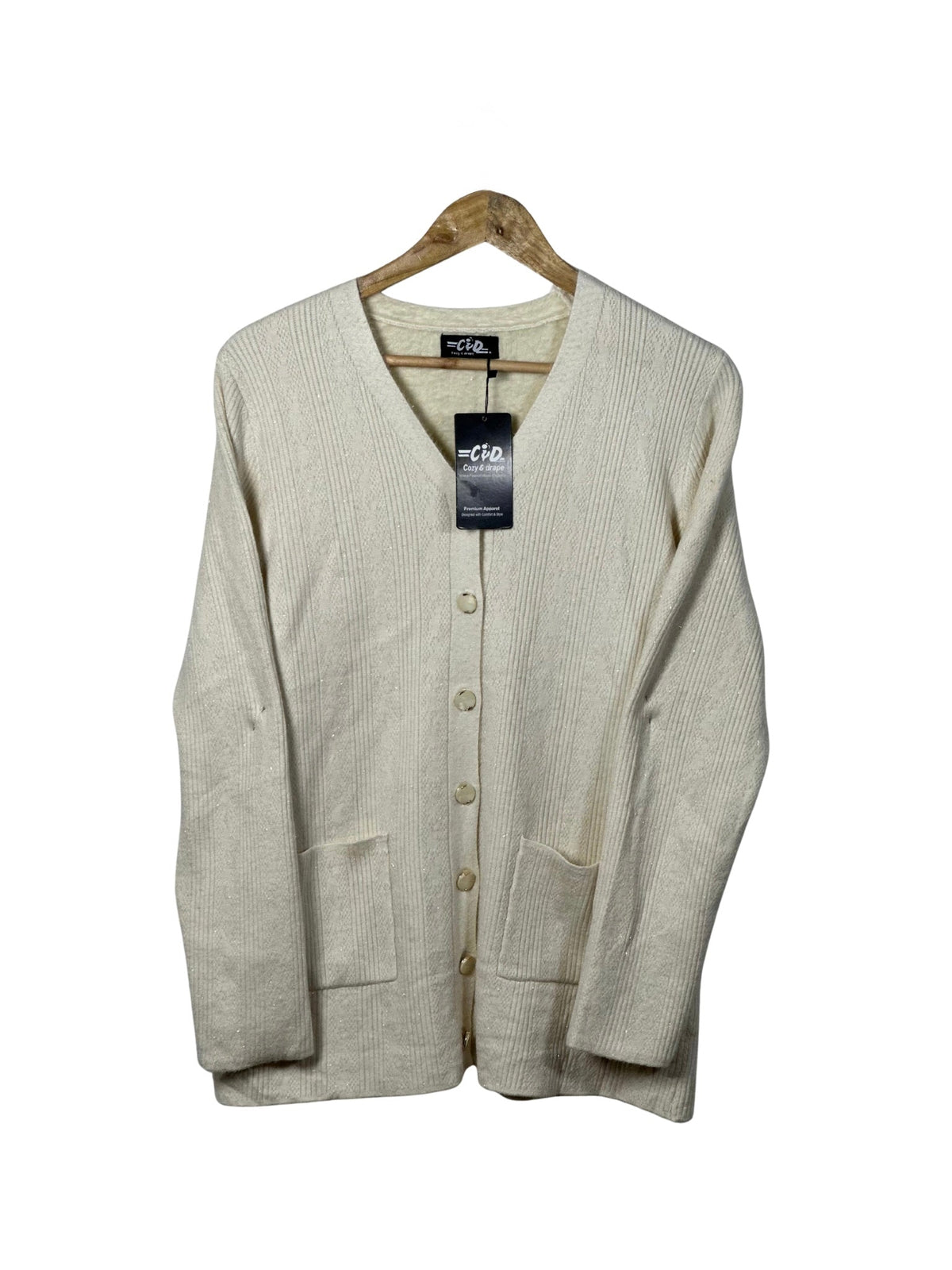 Cozy&Drape cream full-sleeved cardigan sweater with a button-up front and two patch pockets on a wooden hanger