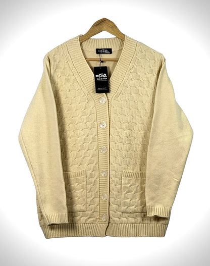 Cozy&Drape cream cable knit cardigan sweater with a V-neck, button-up front, and two patch pockets on a hanger.