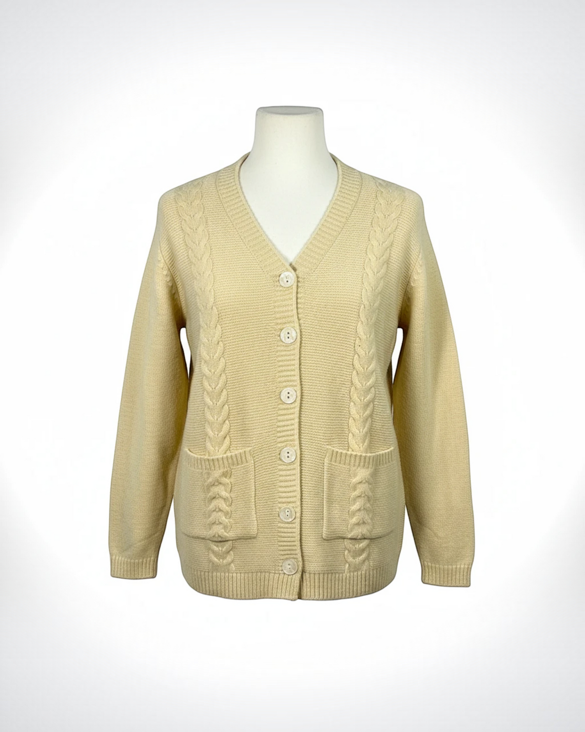 Cozy&Drape cream V-neck button-down cardigan with cable-knit detailing and two front patch pockets on a mannequin.