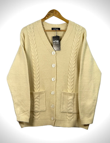 Cozy&Drape cream cable knit cardigan sweater with front buttons and pockets on a wooden hanger
