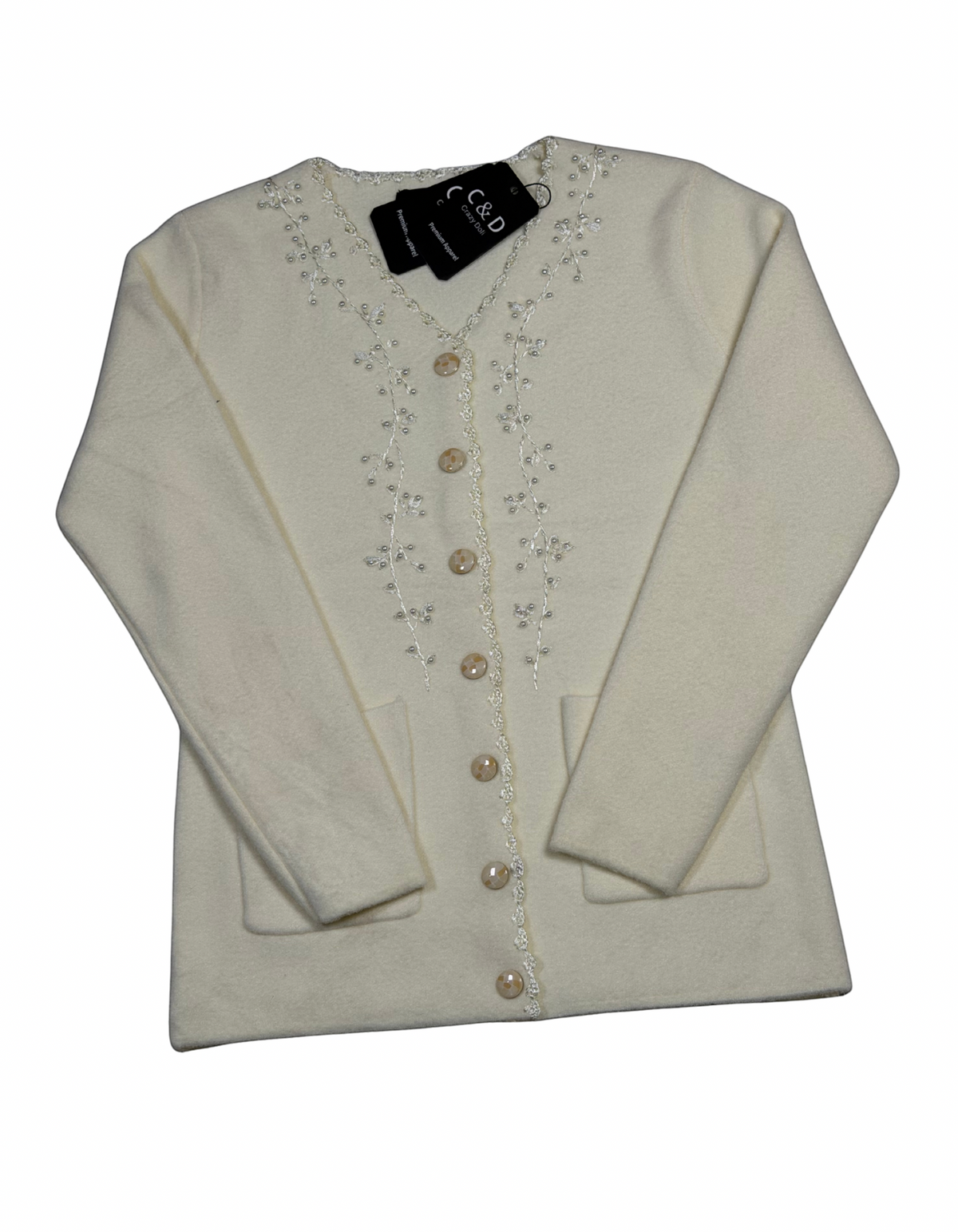 Cozy&Drape cream knit cardigan with V-neck, button front, two pockets, and delicate floral embroidery detail.