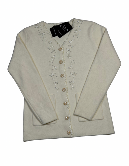 Cozy&Drape cream knit cardigan with V-neck, button front, two pockets, and delicate floral embroidery detail.