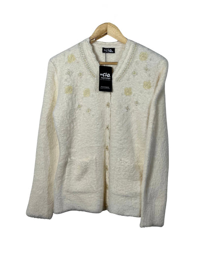 Cozy&Drape cream fuzzy cardigan sweater with pearl and sequin floral embellishments, long sleeves, and front pockets.