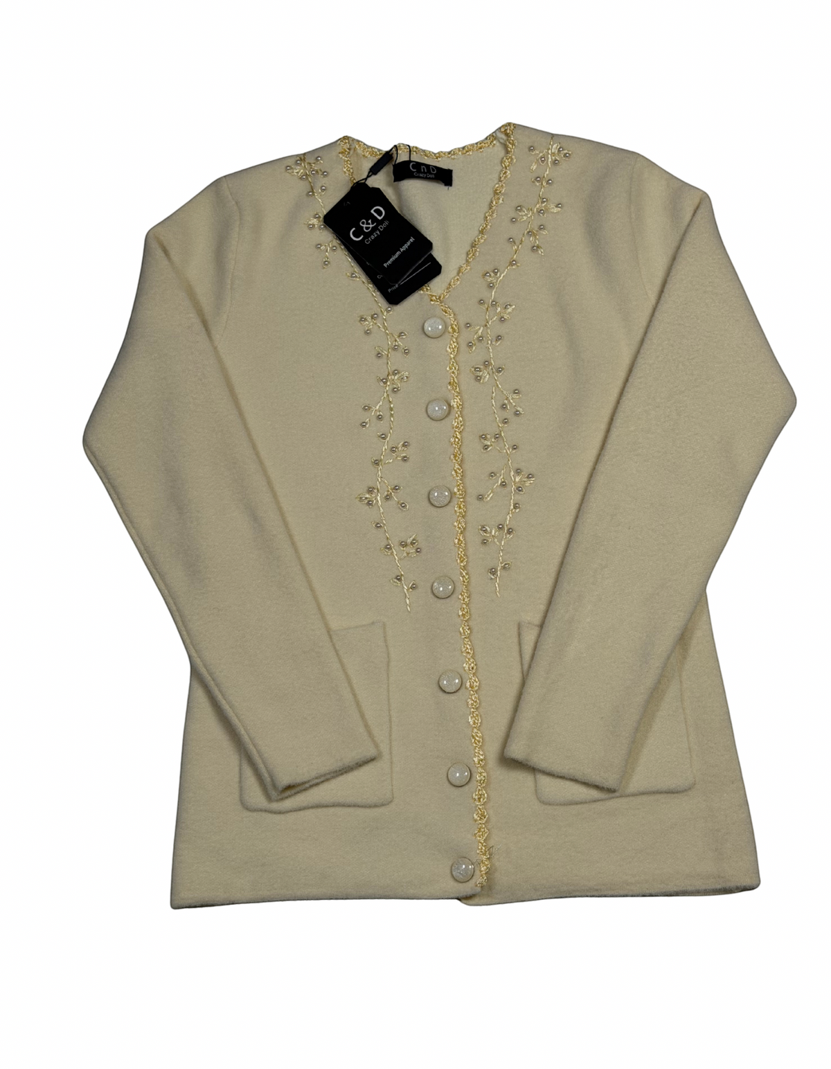 Cozy&Drape cream knit cardigan with V-neck, button front, two pockets, and delicate floral embroidery on the placket.