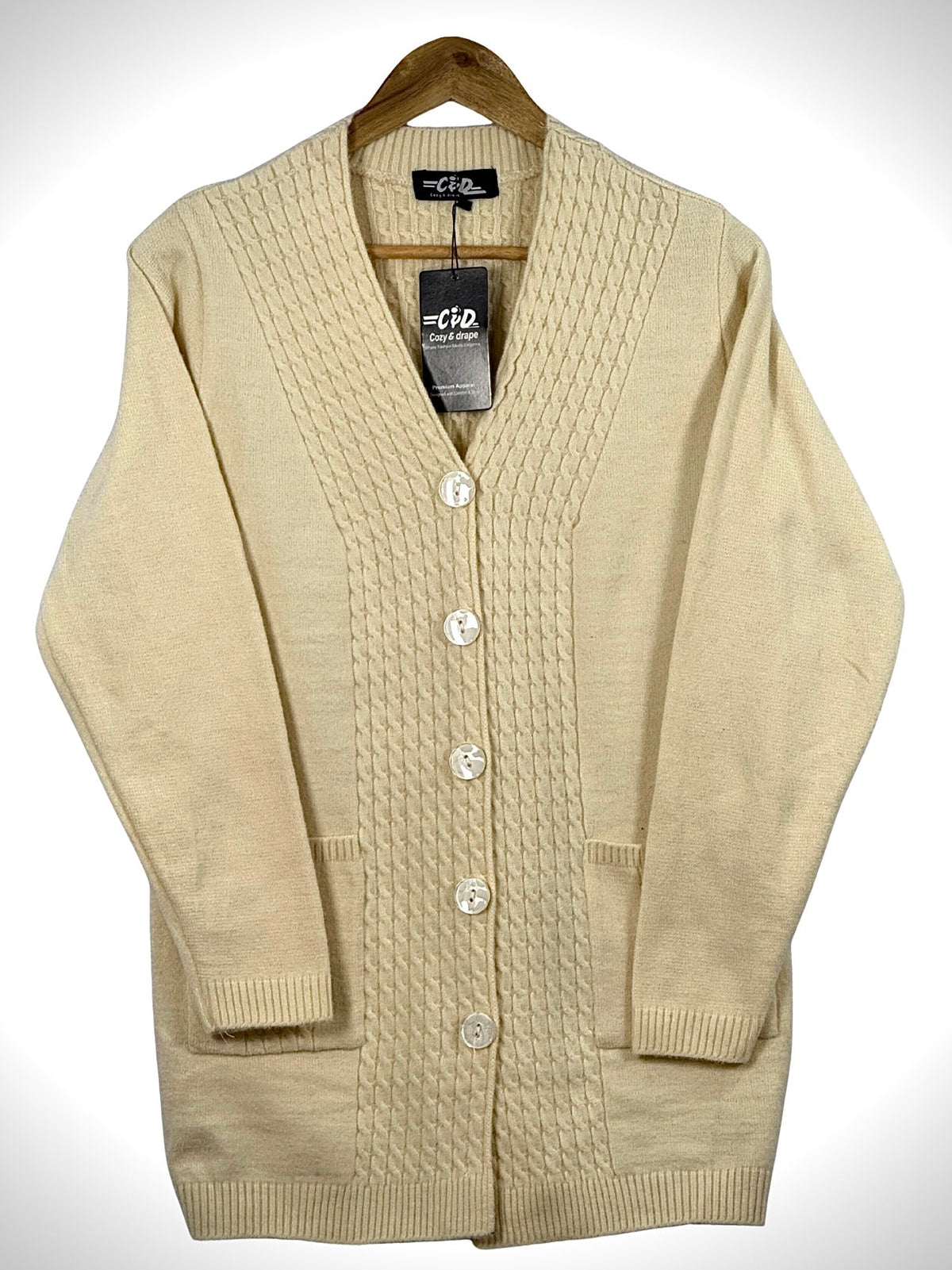 Cozy&Drape cream long cardigan sweater with a cable knit front panel, button closure, and two front pockets.