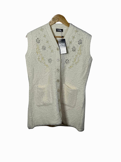 Cozy&Drape cream sleeveless cardigan sweater with floral bead embroidery, button front, and two front pockets.