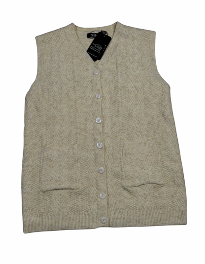 Cozy&Drape sleeveless wool cardigan sweater in cream with a textured chevron pattern, front buttons, and pockets.