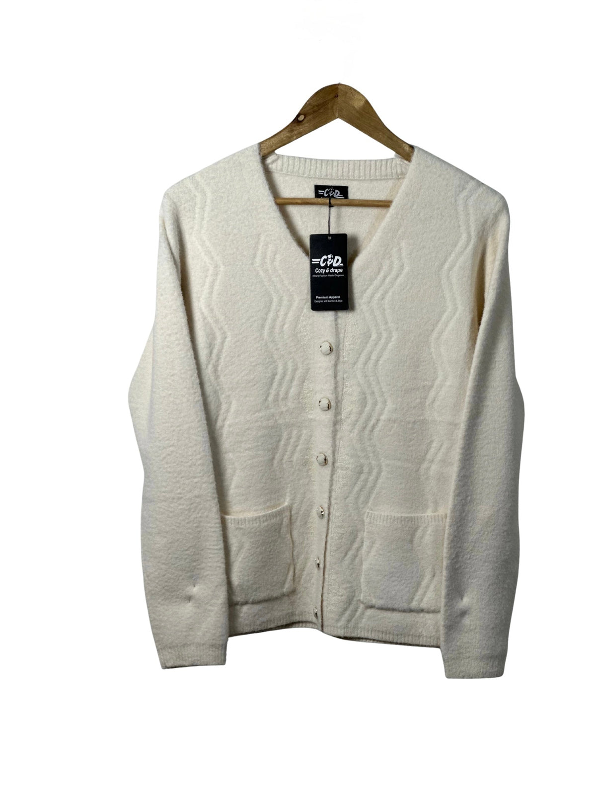 Cozy&Drape cream full-sleeve cardigan sweater with front pockets and textured wave pattern on a wooden hanger
