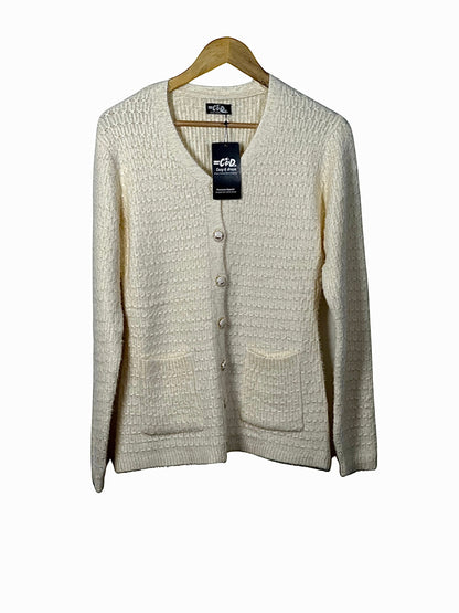 Cozy&Drape cream button-up cardigan sweater with textured knit fabric, V-neck, and two front pockets on a hanger.
