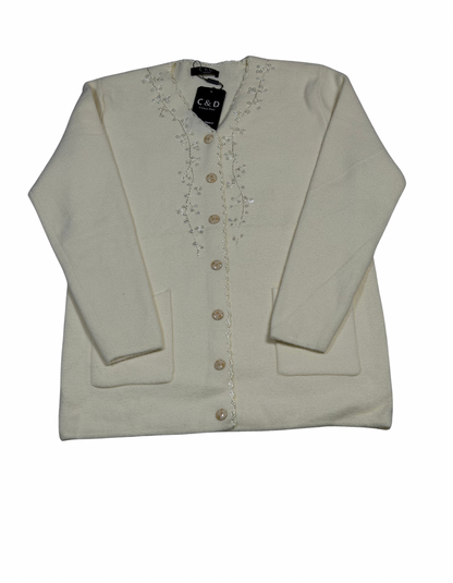 Cozy&Drape cream wool cardigan with front buttons, pockets, and delicate floral bead embroidery on the neckline.