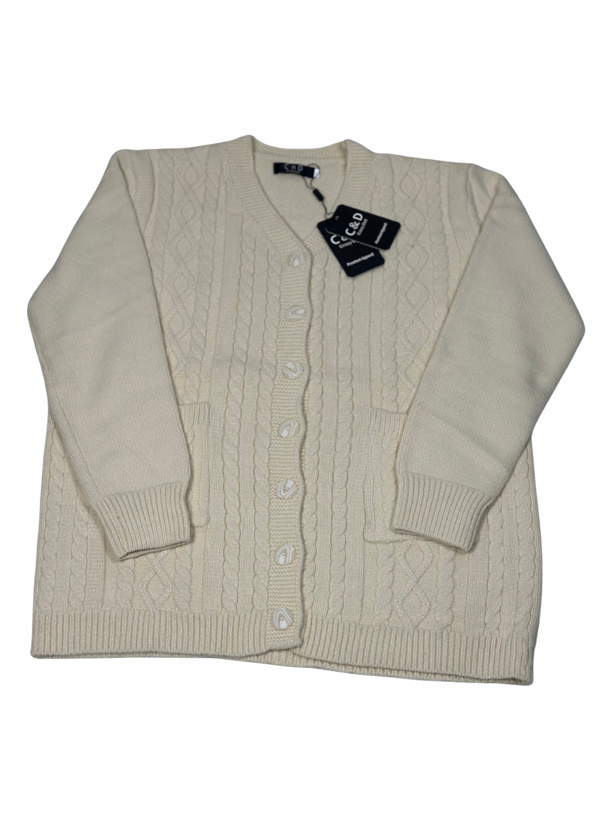 Cozy&Drape cream wool cable knit cardigan with button front, long sleeves, and two pockets.
